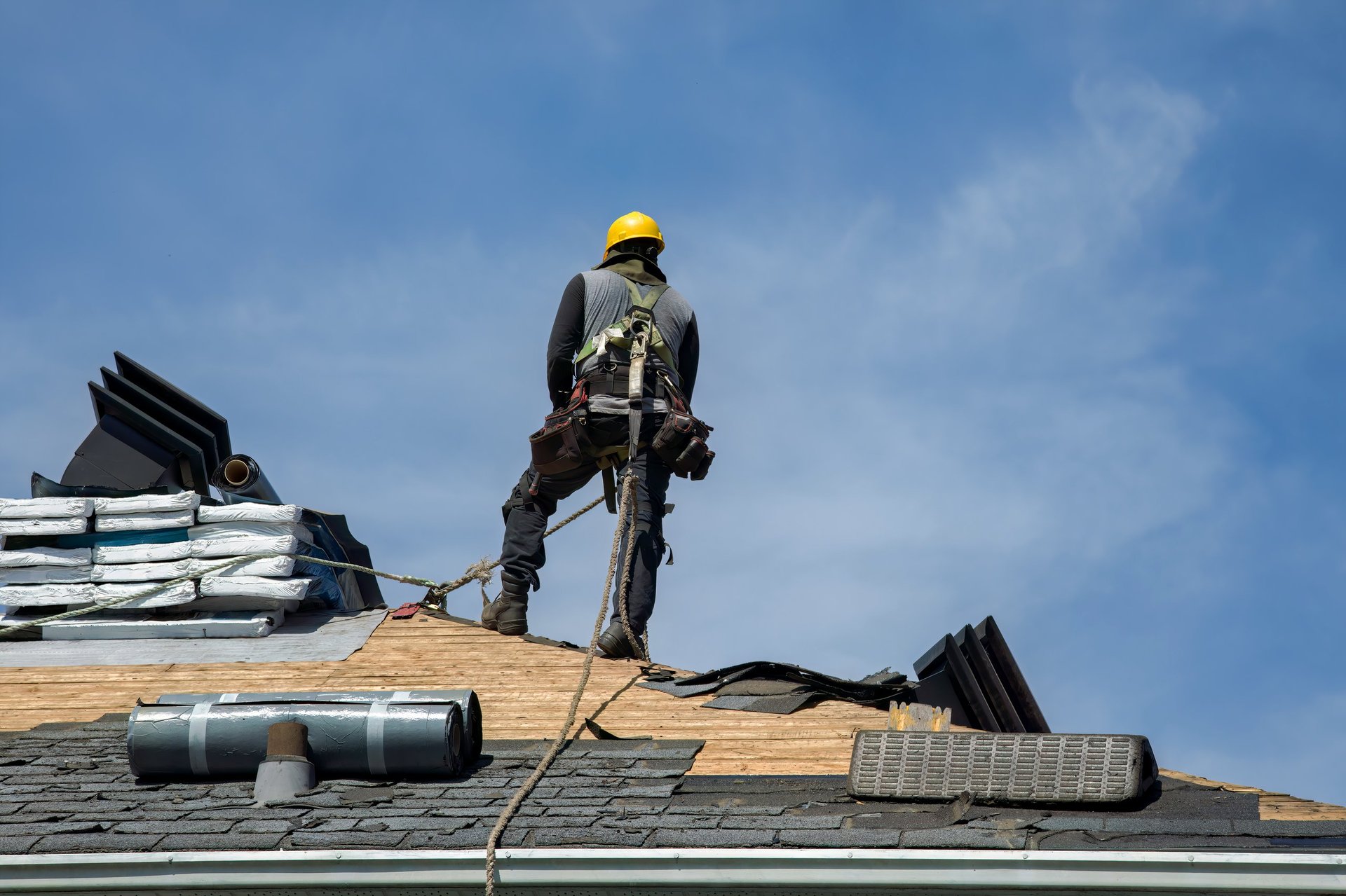 Professional roofer working on residential roof